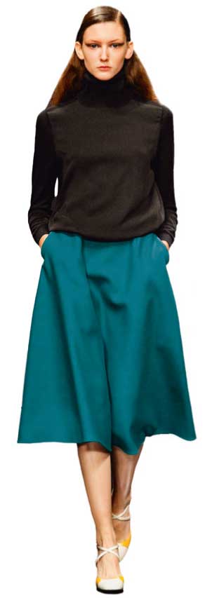 Schwarzer Rollkragenpulli, petrolblauer Midi-Rock, schlichte Eleganz, modisch, zeitlos, klassisch.