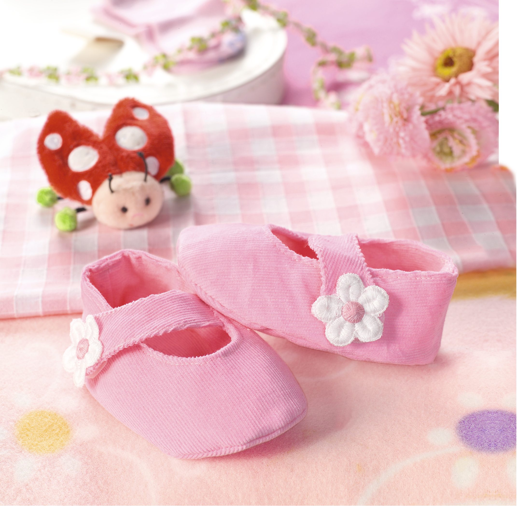 Handgefertigte, rosa Stoffschuhe mit Blumenapplikation. Modische, DIY Babyaccessoires, weicher, gerippter Stoff.