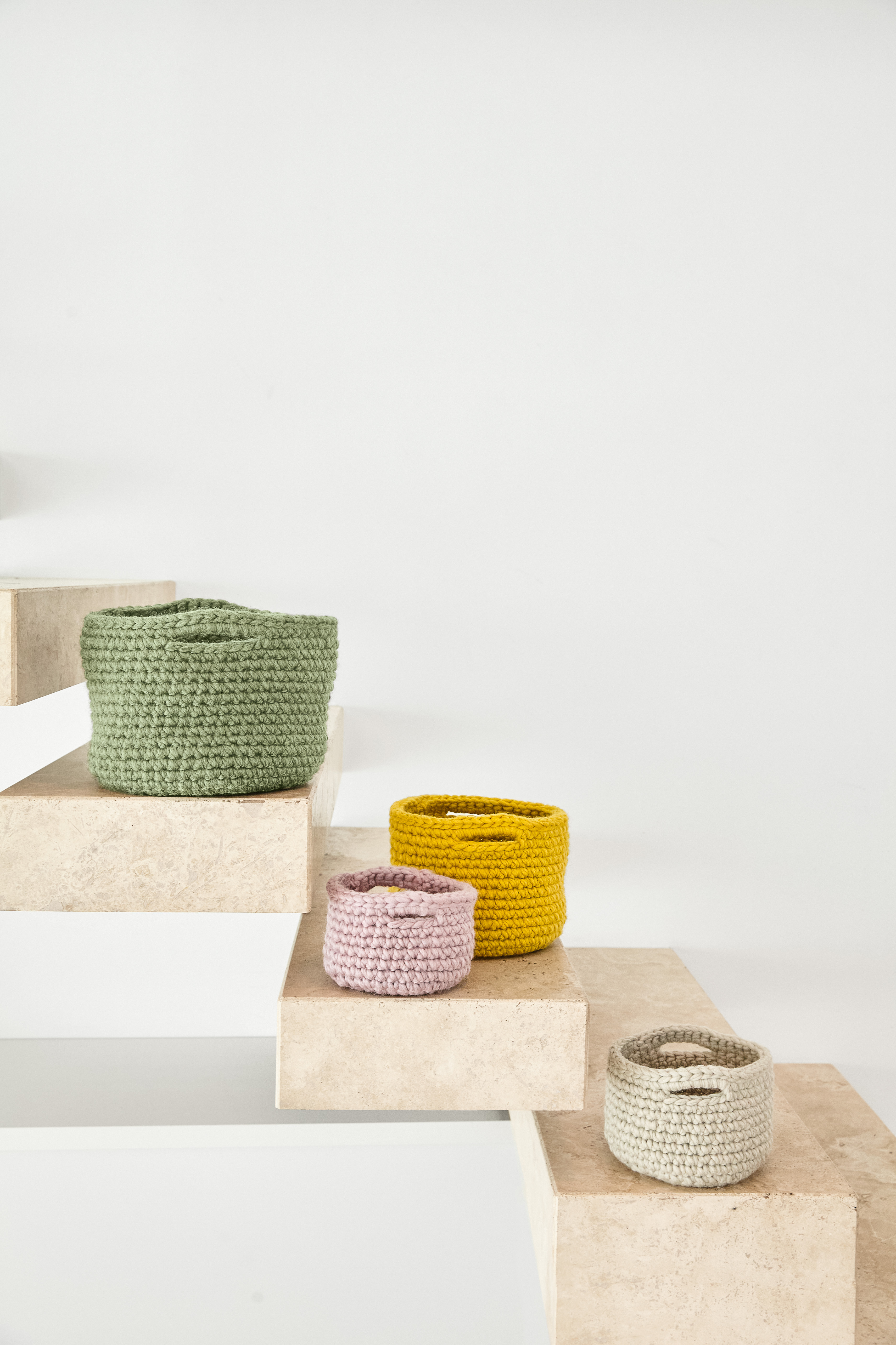 Bunte, gehäkelte Körbe in Grün, Gelb, Rosa und Beige. Modisch, handgemacht, vielseitig einsetzbar.