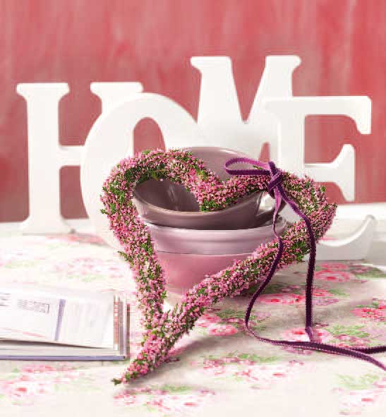 DIY Herz aus Blumen, rosa-lila Farben, dekorativ; akzentuiert Keramikschalen und florales Design.