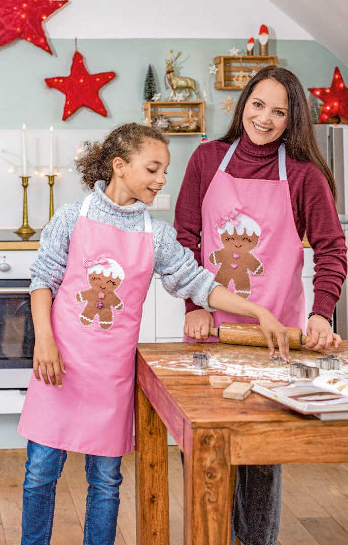 Rosa Schürzen mit Lebkuchenmuster, modisch, handgefertigt, einheitlicher Schnitt, ideal für festliche Aktivitäten.