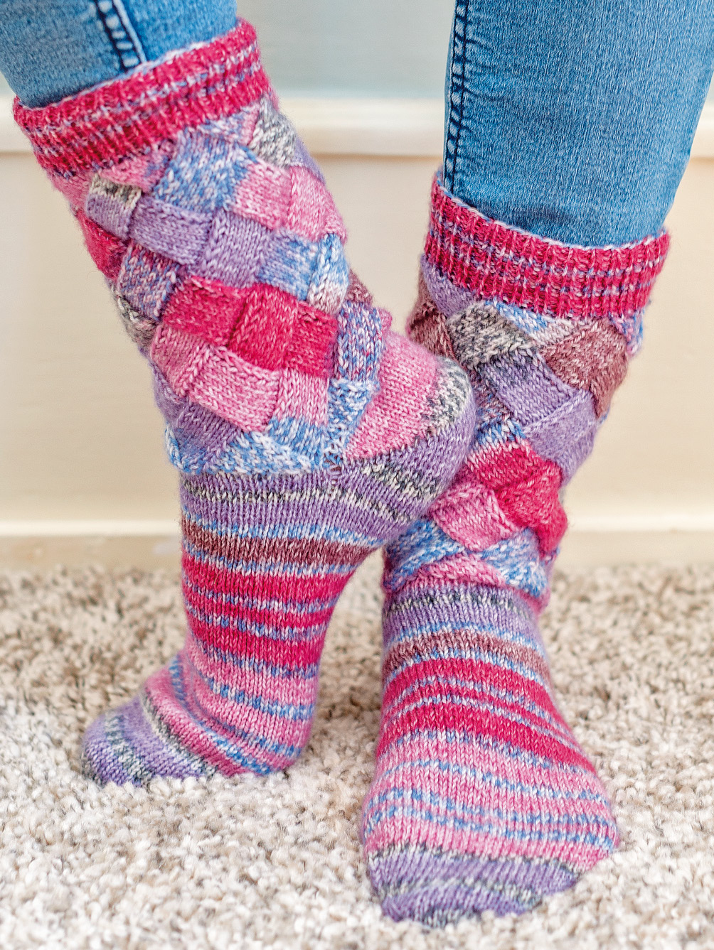 Gestrickte Flechtmustersocken in Beere-Mix