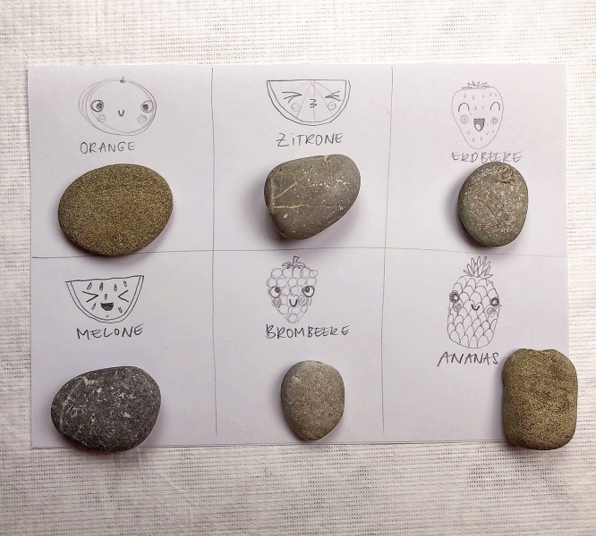 Handgezeichnete, fruchtige Gesichter auf Steinen. DIY, einzigartig und kreativ gestaltet.