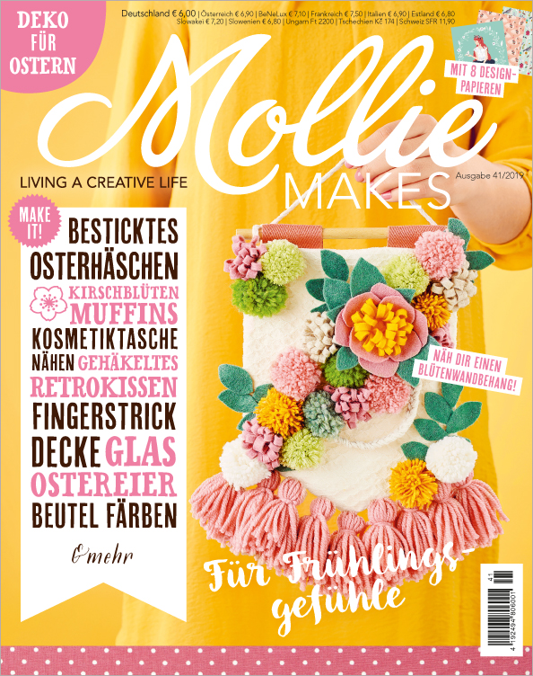 Handgemachter Blütenwandbehang; bunte Pompons, florale Muster; lebendig, kreativ, DIY.