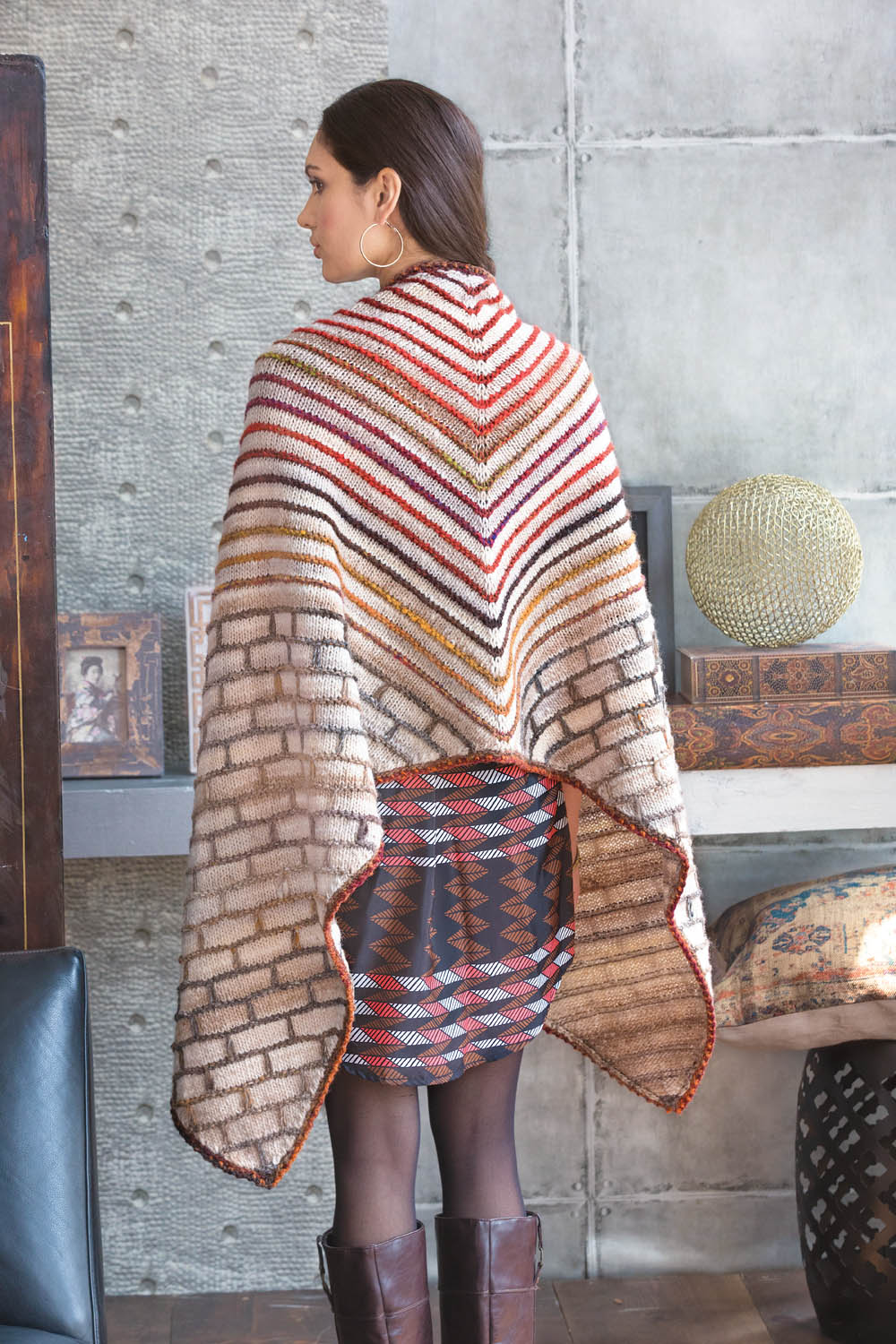 Buntes, handgemachtes Cape mit Streifen und geometrischem Muster, elegant und kreativ.