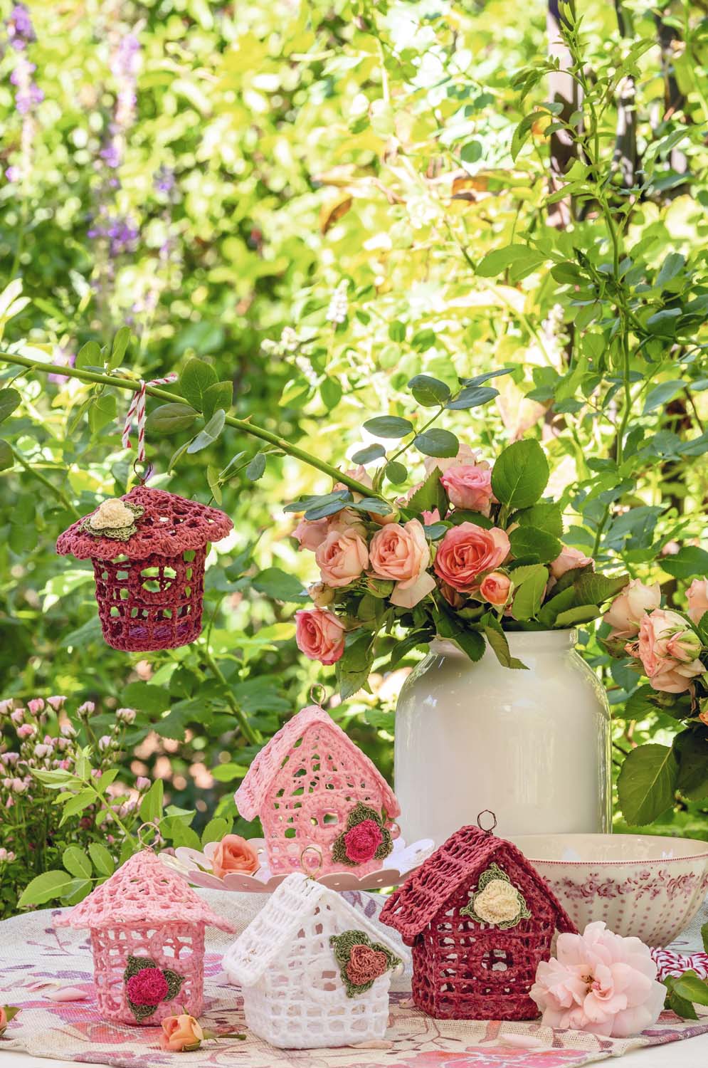 Modische DIY-Häkelhäuser in Rosa und Weiß mit filigranen Mustern, perfekte Handarbeit für charmante Deko.