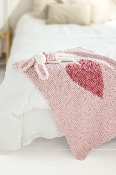 Rosafarbene, gestrickte Decke mit Herzmotiv. Handgemacht, DIY, weiches, gemütliches Design.