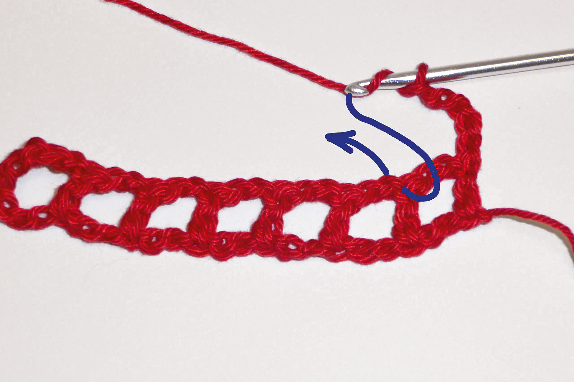 Rotes Häkelmuster, handgemacht, leichtes Gitterdesign, DIY-Look, kunstvoll verarbeitet.