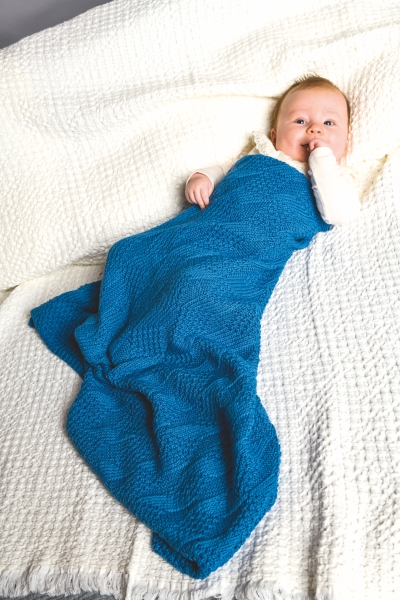 Blaue, gestrickte Decke für Babys. Weich, warm, ideal für Gemütlichkeit. Perfekt für DIY-Liebhaber.