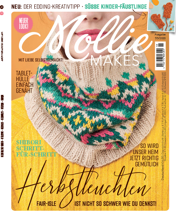 Beiger Strickschal mit farbigem Zickzackmuster. Handgemacht, gemütlich, ideal für Herbstnächte.