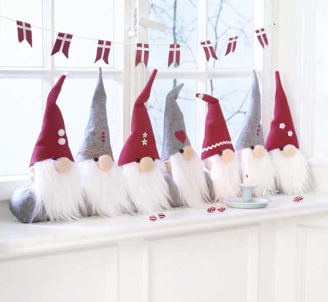Bunte Filzwichtel in Grau und Rot mit Details wie Herzen und Sternen. DIY-Charme, ideal als modische Deko.